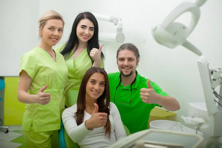 Portrait Of Smiling Dentists In Dental Clinic