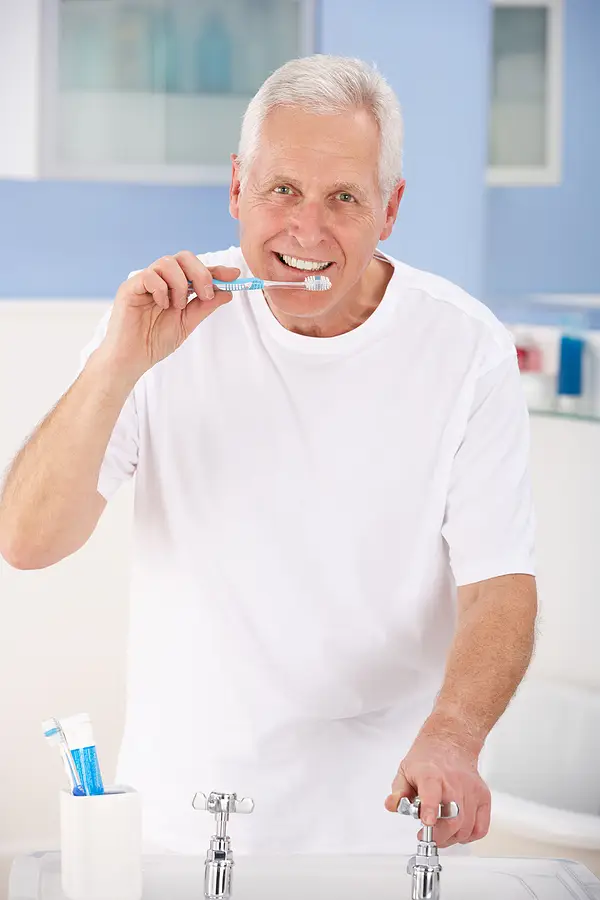 Senior man brushing teeth